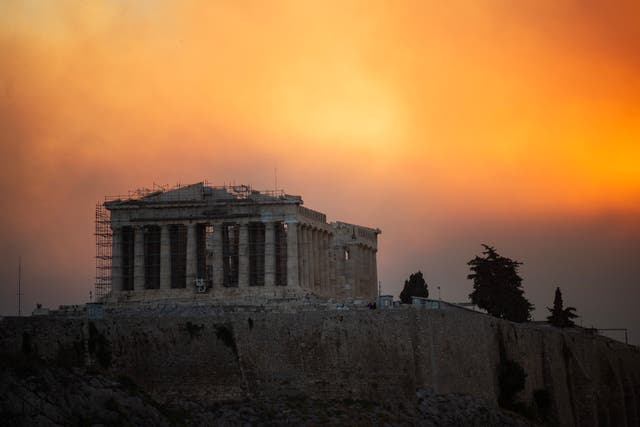 <p>The Parthenon temple atop the Acropolis hill in a smoke cloud from a wildfire, in Athens on August 12, 2024</p>