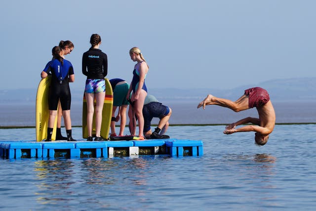 <p>Children enjoying the hot weather on Monday at Clevedon Marine Lake in Somerset (Ben Birchall/PA)</p>