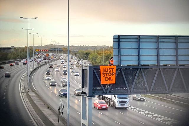 Protesters climbed onto gantries over the motorway for four successive days in November 2022 and brought traffic to a standstill (Just Stop Oil/PA)