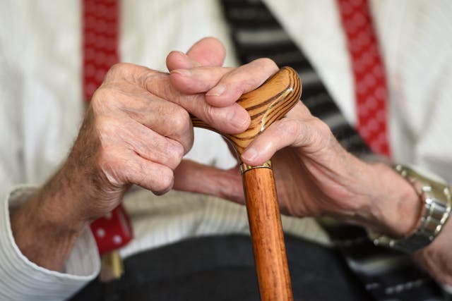 <p>An elderly man holding a walking stick (PA)</p>