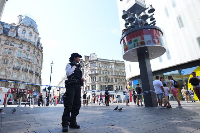 <p>Police officers at the scene in Leicester Square (James Manning/PA)</p>