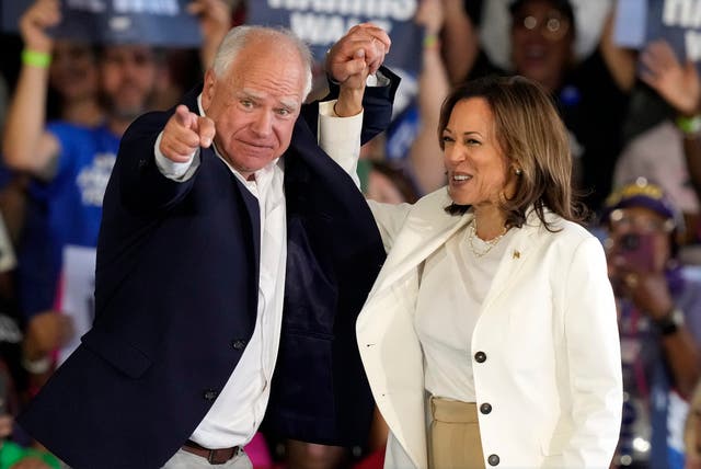 <p>Tim Walz and Kamala Harris arrive at a campaign event </p>