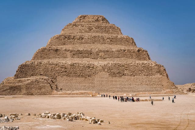 <p>Tourists approach to enter the step pyramid of Djoser at the Saqqara necropolis south of Egypt’s capital Cairo on May 27, 2021</p>