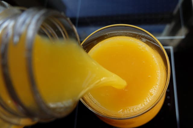 <p>Orange juice is poured into a glass in Miami, Florida</p>