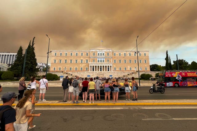 <p>Smoke from wildfires is seen above the Greek parliament building in central Athens on Sunday</p>