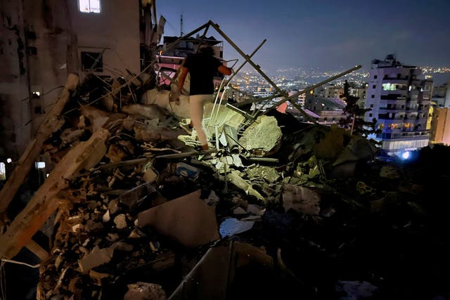 <p>A man inspects a building destroyed by an Israeli airstrike in the southern suburbs of Beirut</p>