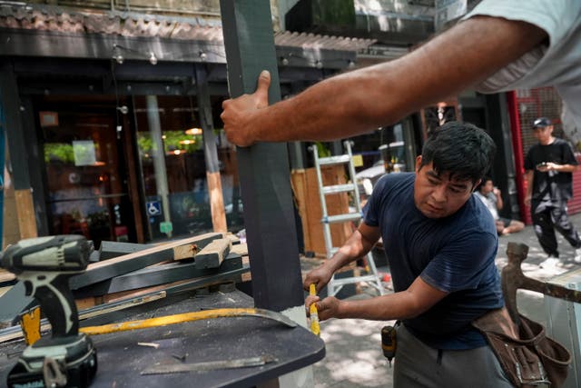 <p>Workers demolish the outdoor dining shed attached to Ruffian Wine Bar, Thursday, Aug. 1, 2024, in New York. The final day for restaurants to register for Dining Out NYC, a new city program regulating outdoor dining spaces, went into effect on August 3, but fewer than 3,000 restaurants in the city are participating </p>