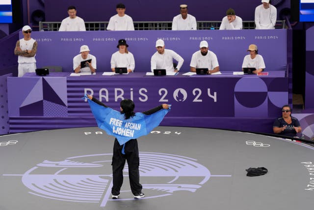 <p>Refugee Team’s Manizha Talash, known as Talash, wears a cape which reads ‘free Afghan women’ as she competes in the Paris Olympics Breaking event </p>