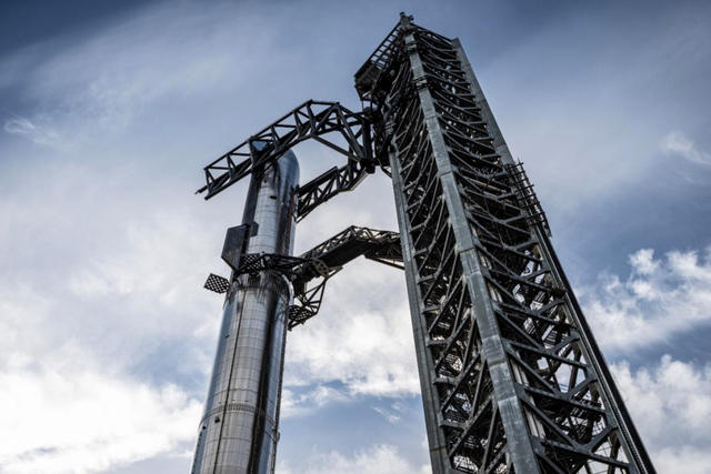 <p>SpaceX’s Starship rocket pictured within the robotic arms of its launch tower at the firm’s Starbase facility in Texas</p>